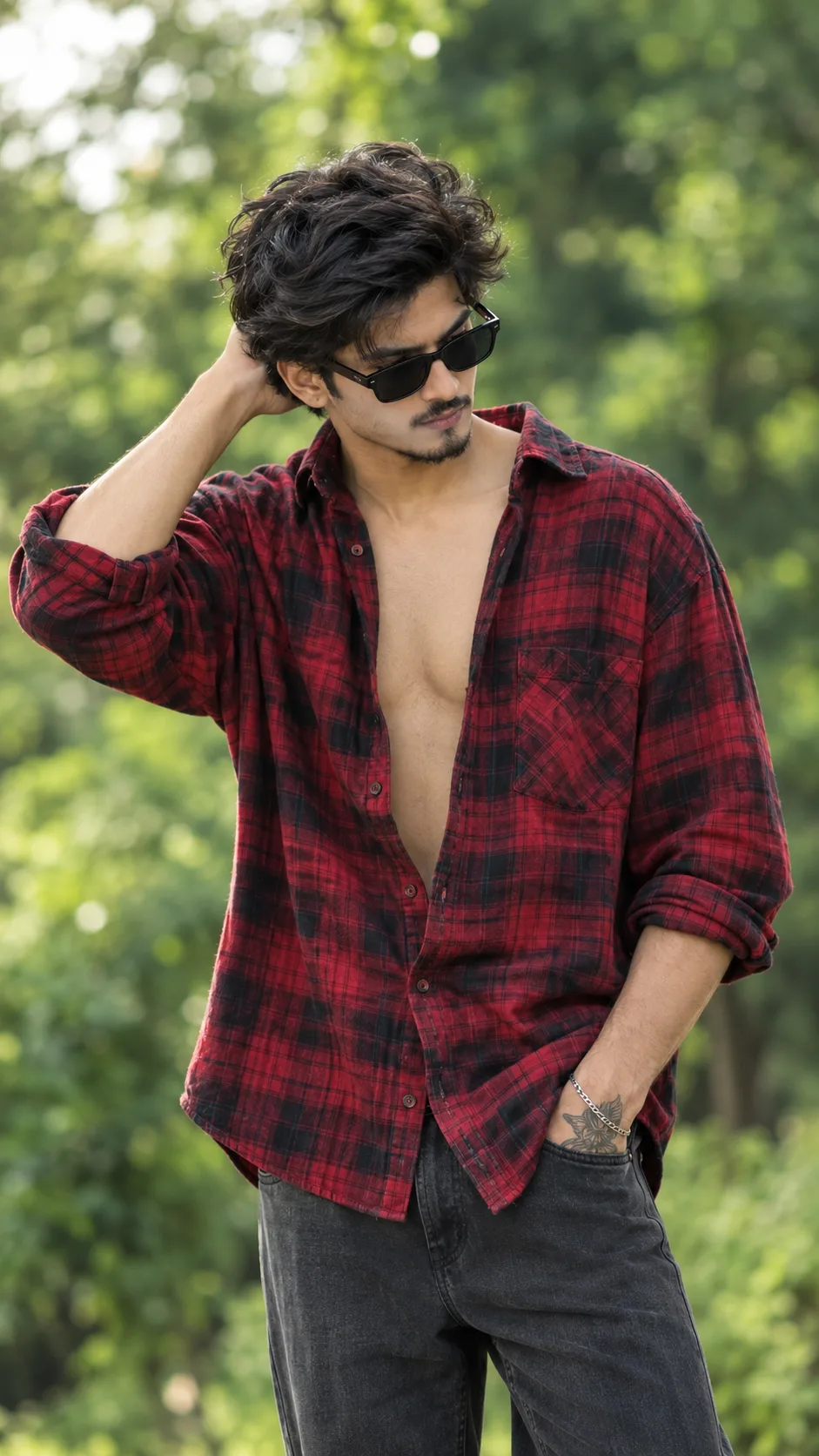 Stylish Young Man in Red Plaid Flannel Shirt and Sunglasses Outdoors