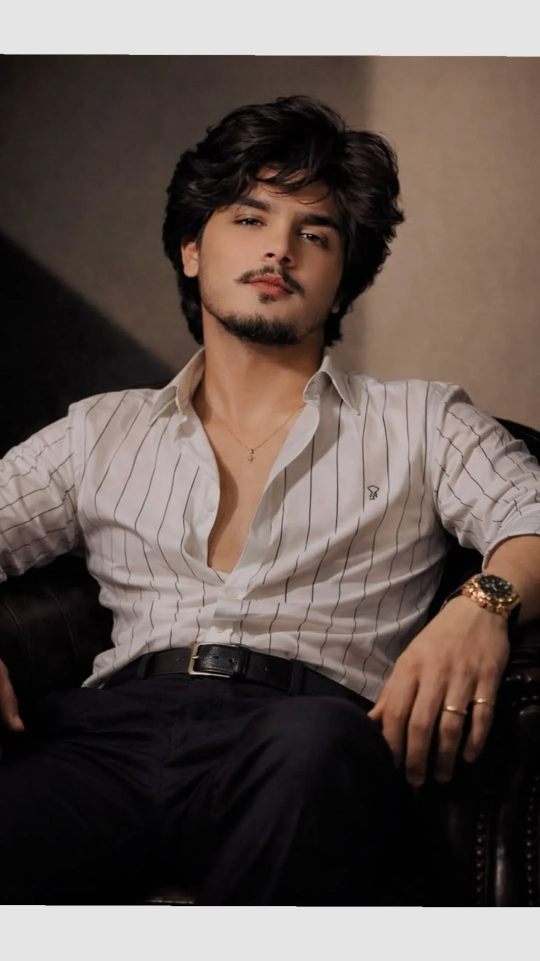 a man sitting in a leather chair,