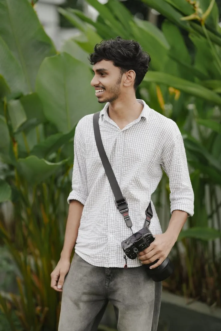 Candid Outdoor Garden Portrait of Young Indian Photographer with Camera