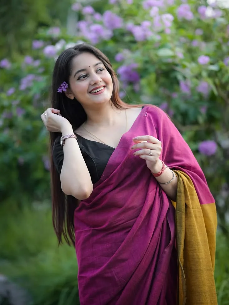 Candid Woman in Magenta Saree with Flower in Hair Smiling in Blooming Garden