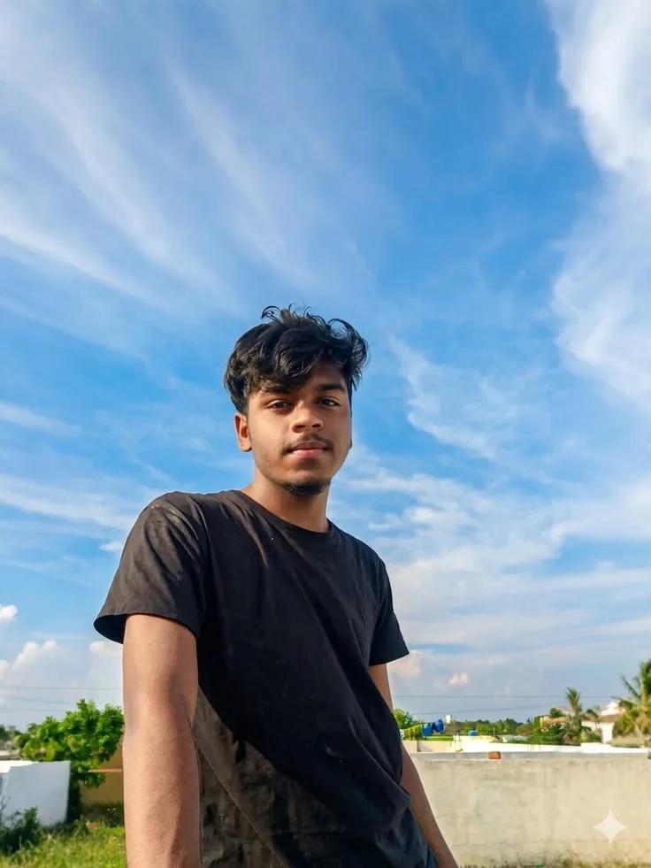 Candid Young Man in Black Crewneck T-Shirt Under Blue Sky on Rooftop