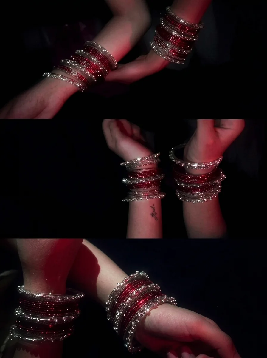 The timeless charm of glass bangles, shimmering softly against the shadows. 🔴✨"