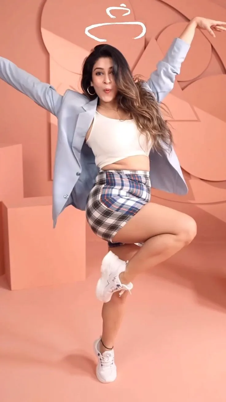 Playful Full-Length Indoor Studio Portrait of Energetic Woman Dancing