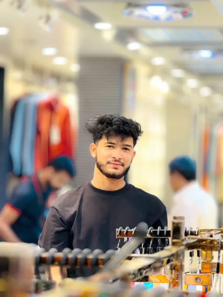 Candid Young Man in Black T-Shirt with Short Beard in Bright Shopping Mall