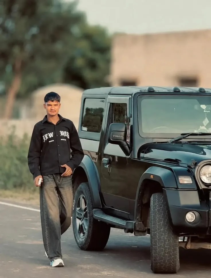 Candid Outdoor Portrait of Young Man Standing beside Black SUV on Country Road