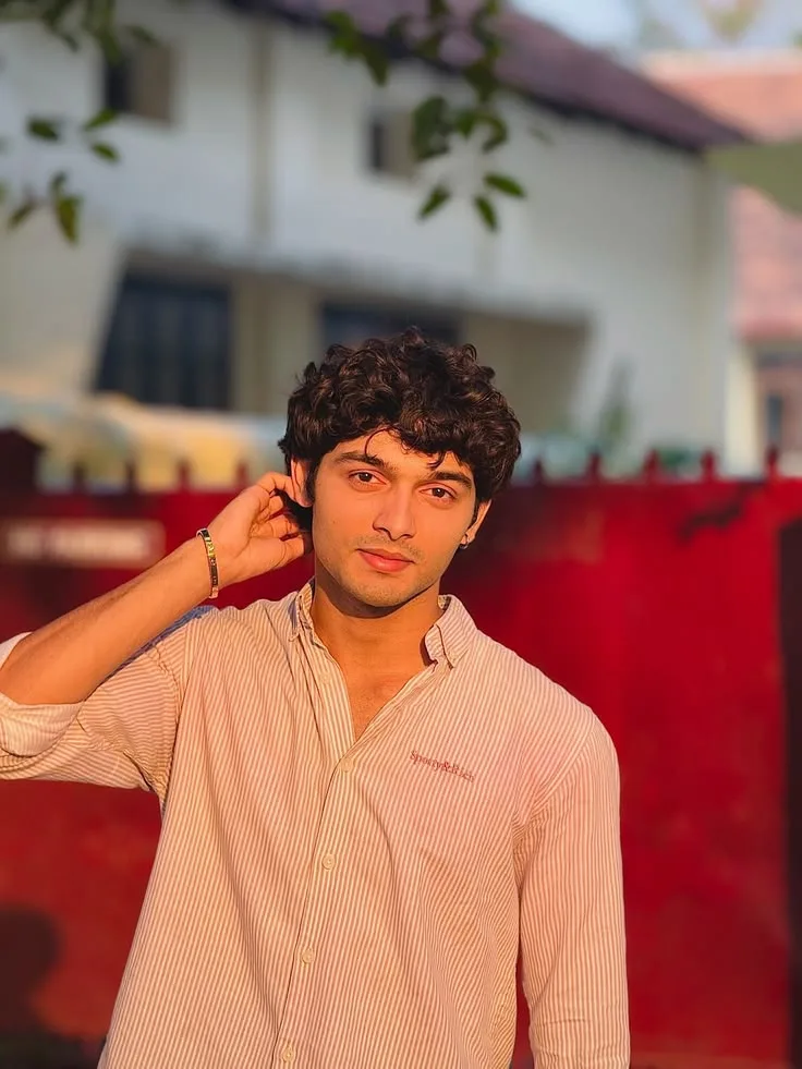 Candid Young Man in Pink Striped Shirt in Golden Sunset Light