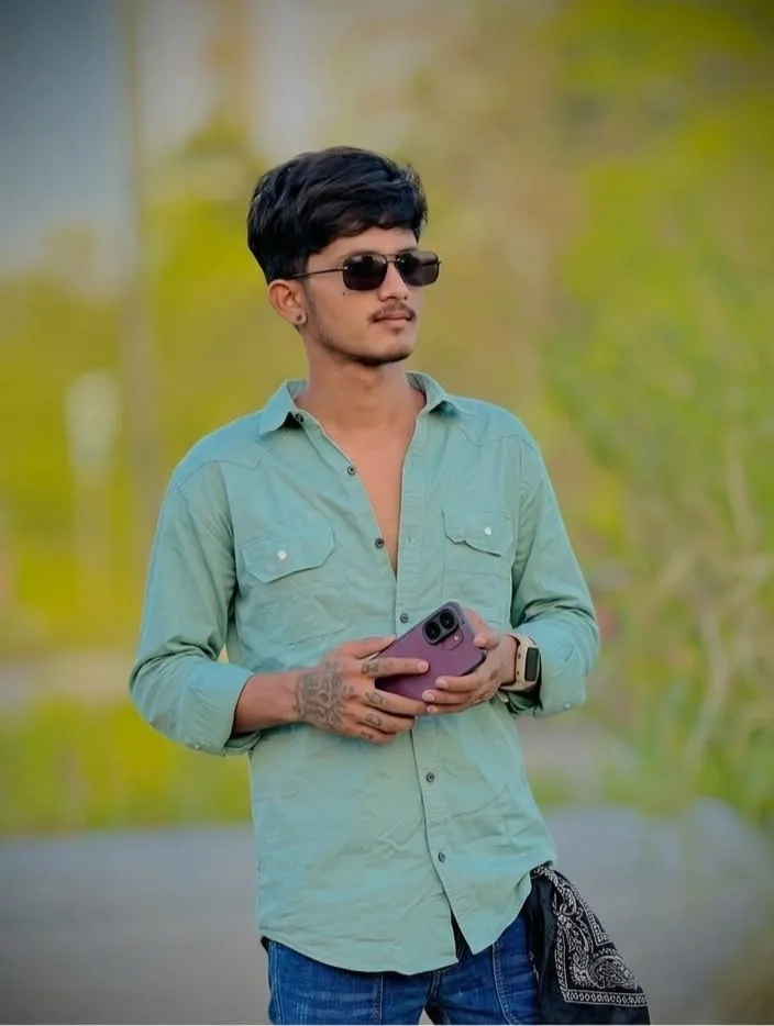 Candid Outdoor Portrait of Young Indian Man Holding Smartphone in Mint Green Shirt