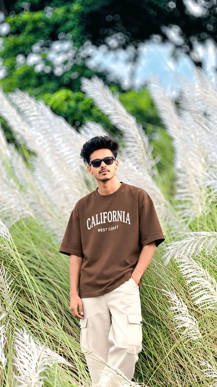 Candid Outdoor Portrait of Young Man in Feathery Grass Field