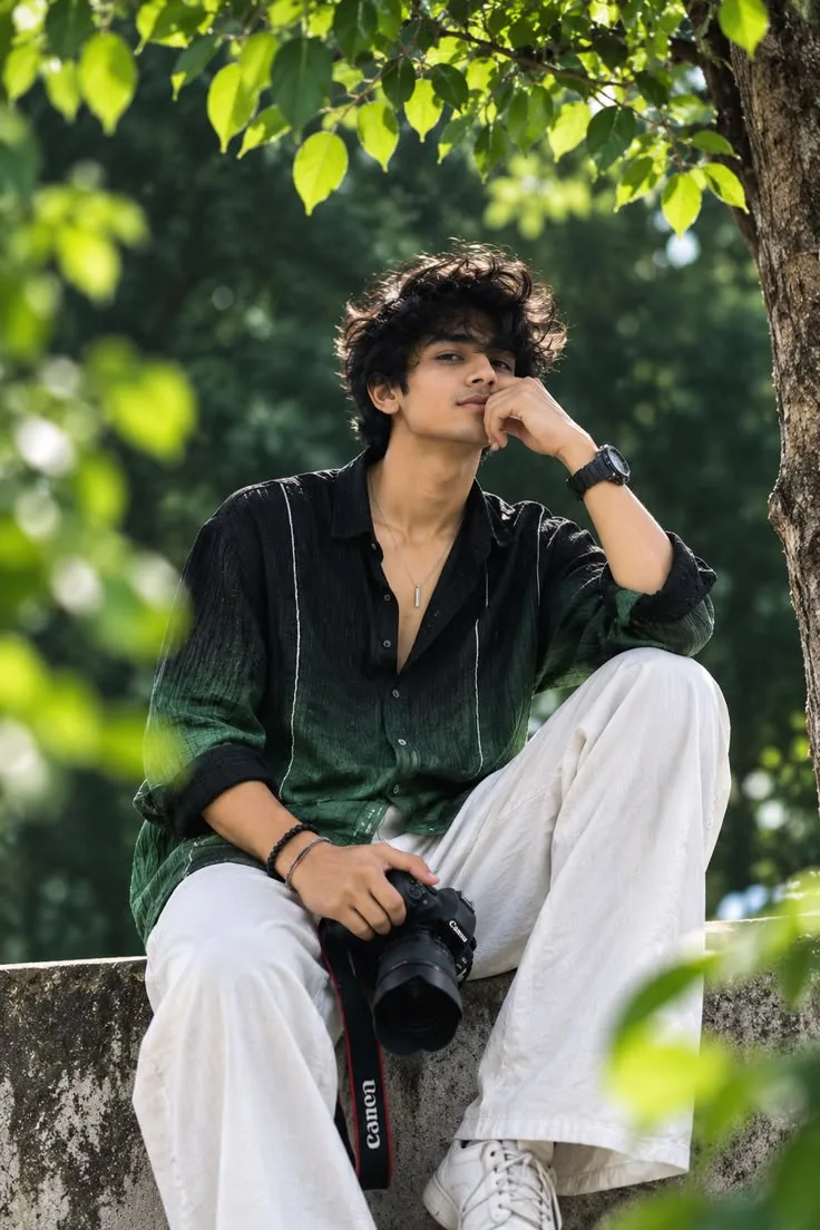 A young man sits comfortably on a concrete ledge