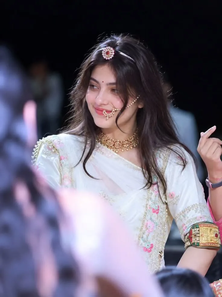 a woman adorned in traditional Indian attire, exuding elegance and poise