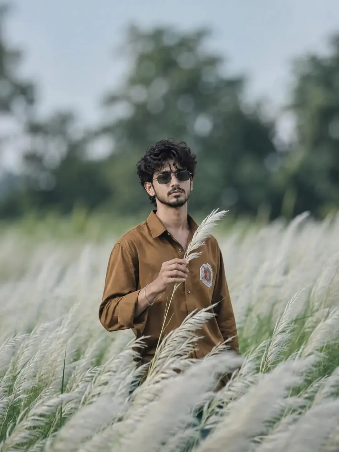 young man standing in a field.