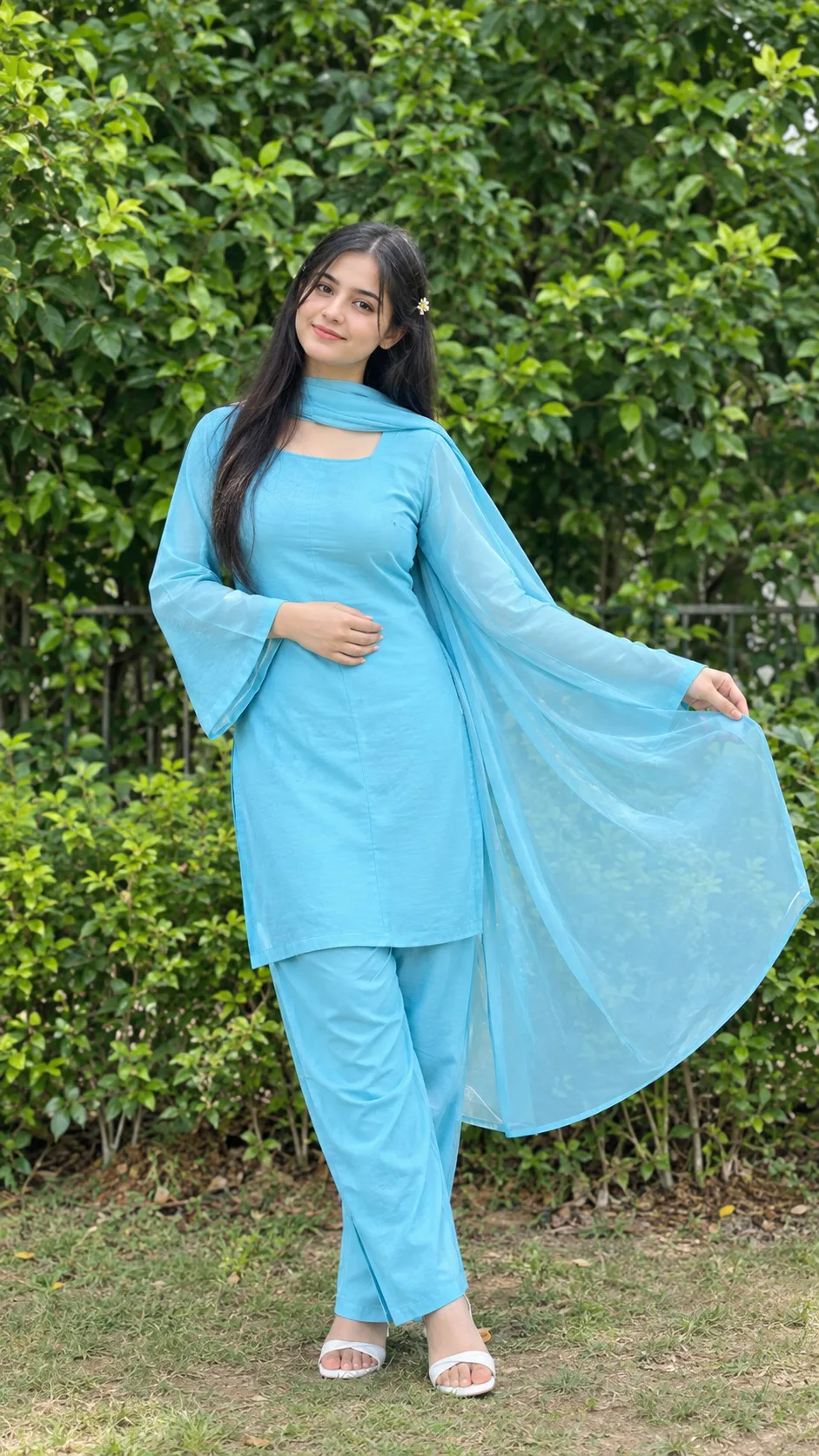 Vibrant Cyan Kurta Portrait of a Smiling Young Woman in a Green Garden